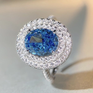 S925 silver ring featuring an oval blue gemstone and double halo diamonds with twisted band