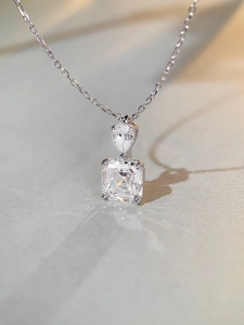 Macro shot of S925 silver necklace with pear and square cut high carbon diamond pendants