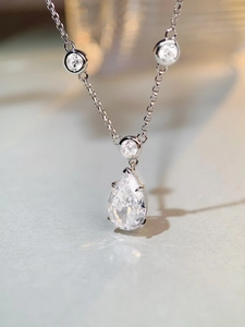 Macro view of pear-cut carbon diamond pendant with S925 silver chain and claw setting