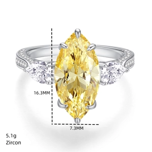 Detailed view of marquise-cut yellow zircon ring with side pear stones and 5.1g weight