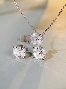 Macro shot of S925 silver jewelry set featuring pear and square cut sparkling zircons