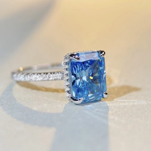 Macro shot of rectangular blue gemstone ring with sparkling pavé-set silver band