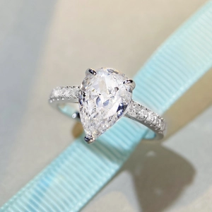 Pear-cut S925 sterling silver ring with radiant crystal and side micro-paved diamonds