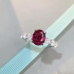 Elegant 925 sterling silver ring featuring an oval red ruby and sparkling side stones