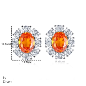 Detail of flower shaped S925 silver earrings with orange zircon and white accents