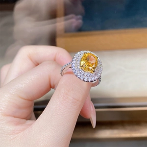 Macro detail of S925 silver ring featuring a large yellow oval ice flower cut gemstone