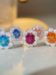 Macro detail of classic oval-cut gemstone rings with a halo of brilliant white zircons