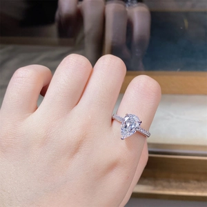 Detail of S925 sterling silver ring with pear cut diamond on woman hand