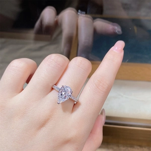 Macro view of a pear-cut solitaire ring with micro-pave diamonds on S925 sterling silver