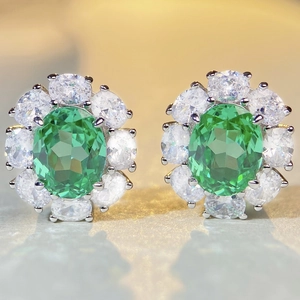 Elegant S925 sterling silver halo stud earrings with emerald green oval-cut center stones