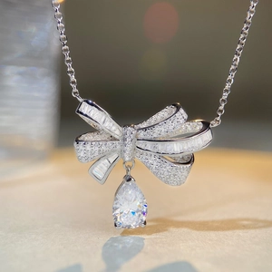Elegant S925 sterling silver bow necklace with pave diamonds and pear-shaped drop pendant