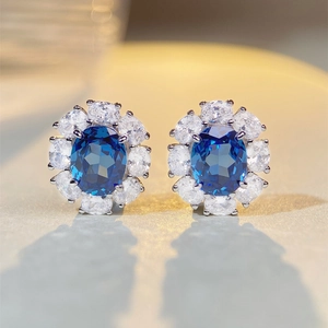 S925 sterling silver halo stud earrings with oval blue gemstones and sparkling diamonds