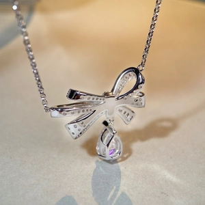 Elegant S925 sterling silver bow necklace with pave diamonds and a pear-cut drop stone