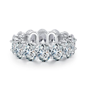 Eternity ring with oval-cut clear stones in silver setting on white background
