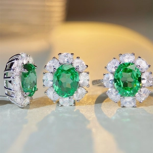 Elegant S925 silver jewelry set featuring emerald-green oval gemstones and halo crystals
