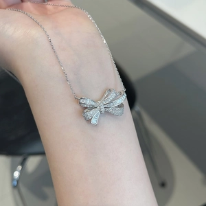 Detail of S925 sterling silver bow necklace with micro-paved sparkling zircons