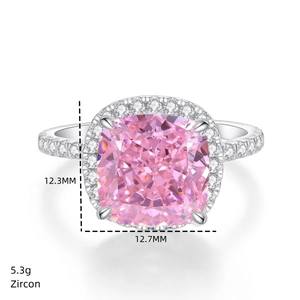 Macro view of 5ct pink cushion-cut zircon ring with halo diamonds weighing 5.3g