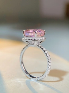 Macro side view of cushion-cut pink carbon diamond ring with halo pavé setting in S925 silver