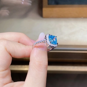 Macro shot of S925 silver ring featuring a large square blue gemstone with halo diamonds