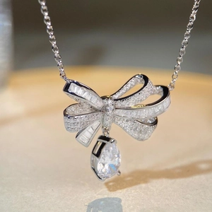 Elegant S925 sterling silver bow necklace with full diamond inlay and pear-shaped drop stone