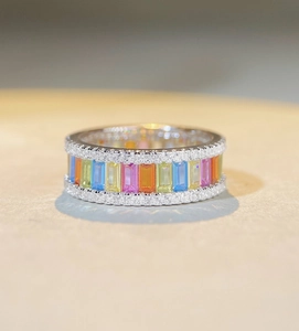 Macro shot of S925 silver rainbow eternity ring with baguette-cut stones and crystal pavé