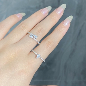 Close-up of S925 sterling silver rings with pear-cut stones on a finger