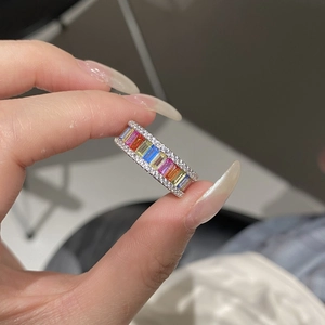 Detailed shot of S925 sterling silver rainbow ring with colorful zircon stones on finger