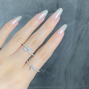 Macro shot of S925 sterling silver teardrop rings stacked on fingers with pavé settings