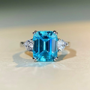 S925 silver ring featuring emerald-cut blue topaz and pear-shaped side moissanites