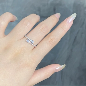 Detailed view of S925 silver ring featuring pear-cut stones and pavé accents on finger