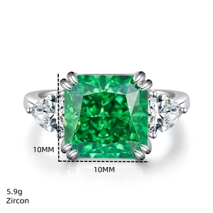 Macro shot of 5 carat square emerald green zircon ring with side pear-shaped stones