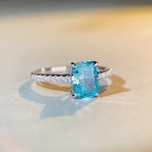 Macro view of aquamarine radiant cut ring with pavé diamond band in S925 sterling silver