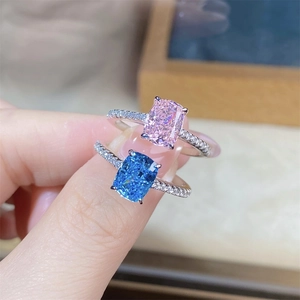 Macro detail of radiant cut aquamarine and pink stones on pavé diamond bands