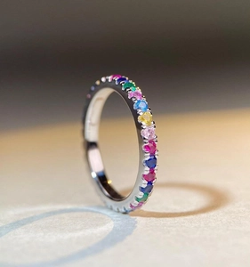 Macro shot of silver ring featuring rainbow zircons and prong setting craftsmanship