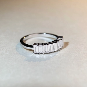 Macro shot of S925 silver ring featuring nine baguette-cut rectangular cubic zirconia stones