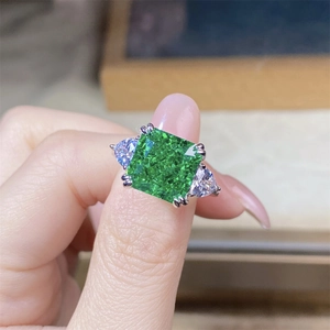 Macro shot of 925 silver ring featuring 5ct emerald green zircon with side stones