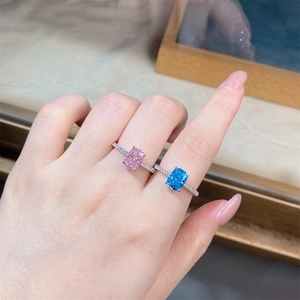 Close-up of S925 sterling silver rings with radiant cut pink and blue gemstones