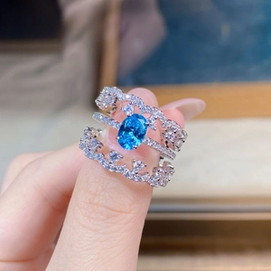 Detailed close-up of S925 silver lace ring with oval sea blue stone and pavé zircon