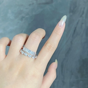 Detail of S925 sterling silver rings with emerald and pear cut zircon stones on hand