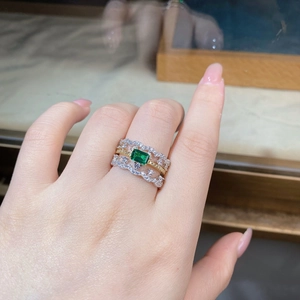 Macro detail of S925 silver lace rings set with emerald cut green gemstone and pavé diamonds