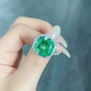 Macro detail of S925 silver ring featuring square halo emerald green carbon diamond
