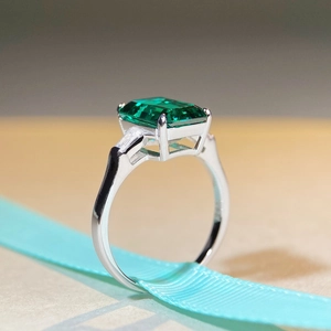 Classic 925 sterling silver emerald cut ring with a 5-carat green gemstone on a blue ribbon