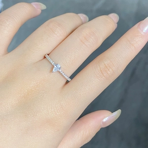 Detailed macro of a pear-shaped zircon ring with a micro-pave diamond-set silver band