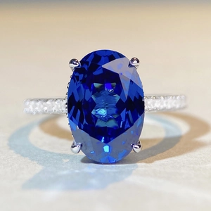 Luxury oval 6ct sapphire ring in silver setting with shimmering pave diamonds