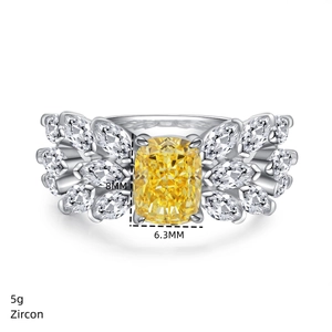 Macro shot of 2ct yellow radiant cut zircon ring with feather-like marquise accents