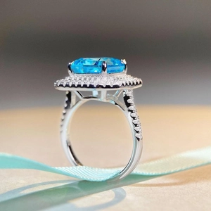 Luxurious S925 silver ring with radiant-cut blue gemstone and halo pavé diamonds