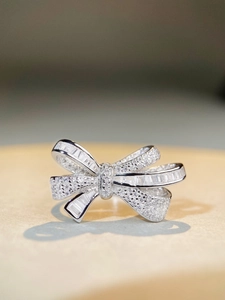 Macro shot of silver bow ring with square zircon and pave-set diamonds on S925 band