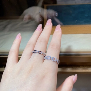 Close-up of S925 sterling silver chain link rings with pavé diamonds on a hand
