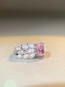 Macro view of radiant cut pink stone and marquise-cut side stones on silver ring