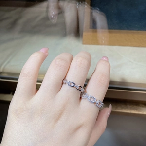 Detail of S925 sterling silver chain rings with sparkling zircon pavé on model's hand